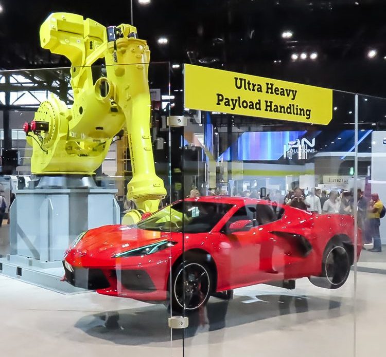 FANUC's high-payload robot lifting a sports car, demonstrating its impressive capabilities. 