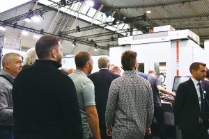 A large crowd gathered to watch the machining demonstration on the Hermle C 42 U MT 5-axis machining center