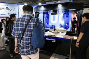 Visitors said, “I want one at home,” after watching Yaskawa’s table-clearing robot demonstration. 