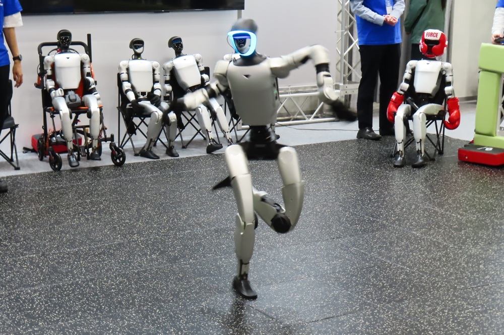 A humanoid robot dancing at the TechShare booth 